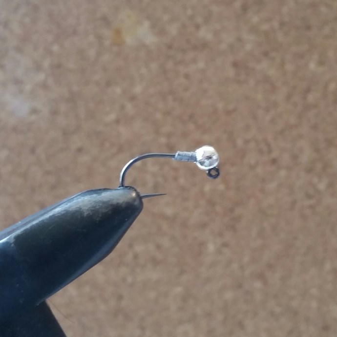 Thread your chosen slotted bead on to the jig hook and position round and over the angle. Wrap 1-4 turns of lead wire depending on the weight you require. Remember though, more lead wire equals more bulk.